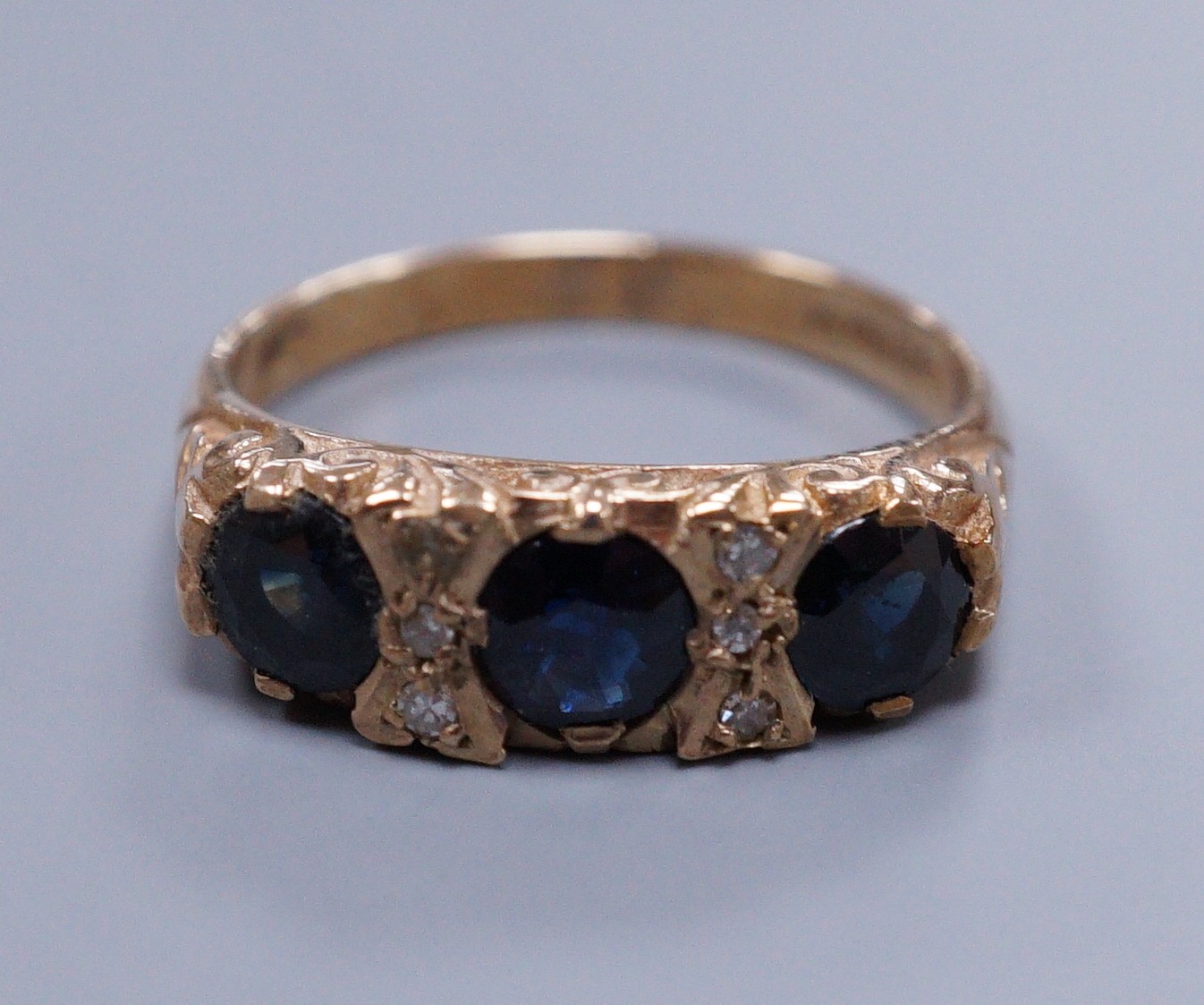 A 9ct gold sapphire and diamond half hoop ring, size O, gross 4 grams